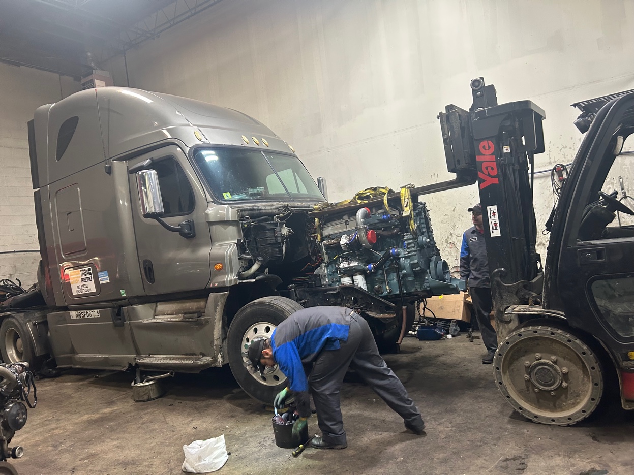 Mechanic working on truck engine